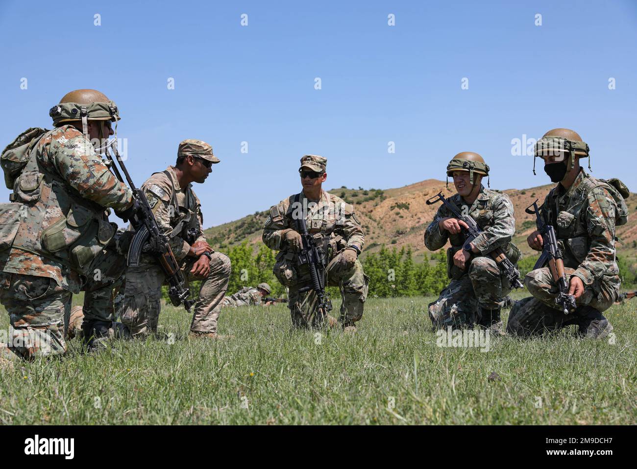 4th Security Force Assistance Brigade and North Macedonian Soldiers hold an after action review after completing battle drills rehearsal during Exercise Swift Response on May 17, 2022 near Krivolak Training Area, North Macedonia. The purpose of this exercise is to present combat credible Army forces in Europe and Africa, and enhance readiness by building airborne interoperability with Allies and Partners and the integration of joint service partnership. Stock Photo