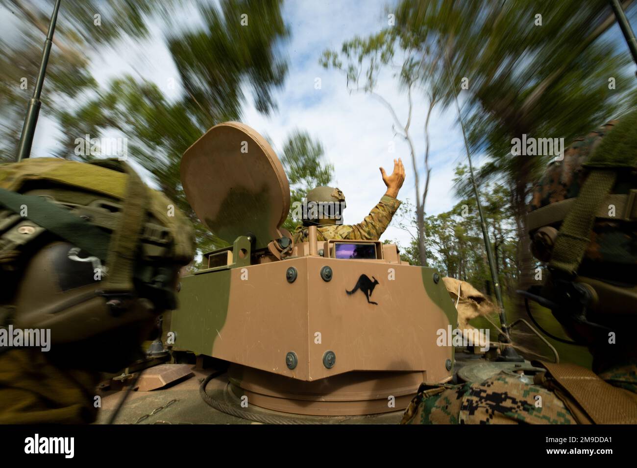 Australian Army Sgt. Jarred Gouma (Center), an M113 Armored Personnel Carrier vehicle commander, speaks to U.S. Marine Corps Lt. Col. Duncan French (right), executive officer, Marine Rotational Force-Darwin (MRF-D) 22, and Lt. Col. Richard Niessl, commanding officer, 6th Battalion, Royal Australian Regiment, 7th Brigade, during exercise Southern Jackaroo 22 at Shoalwater Bay Training Area, Queensland, Australia, May 18, 2022. Southern Jackaroo is a multilateral exercise carried out by Marines with MRF-D, the Australian Army and Japan Ground Self-Defense Force soldiers, focusing on live-fire an Stock Photo