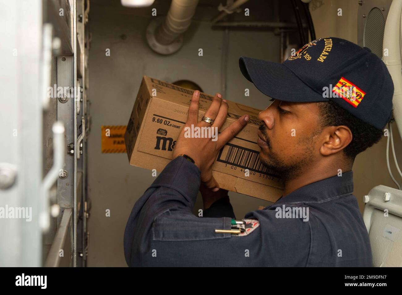 220517-N-UP745-1347 TYRRHENIAN SEA (May 17, 2022) Retail Services Specialist 3rd Class Abel Zewde, from New York, stores stock in a bulk storeroom aboard the Arleigh Burke-class guided-missile destroyer USS Jason Dunham (DDG 109) in the Tyrrhenian Sea, May 17, 2022. Jason Dunham is on a scheduled deployment in the U.S. Naval Forces Europe area of operations, employed by U.S. Sixth Fleet to defend U.S., Allied and Partner interest. Stock Photo