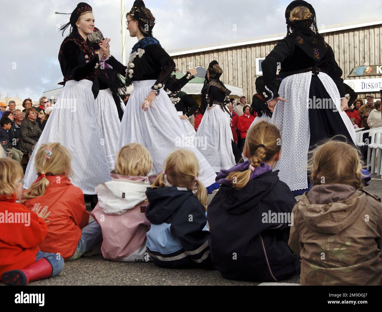Children watching dancers in Frisian Costumes at midsummer festival on Amrum, North Frisian Islands, Germany Stock Photo