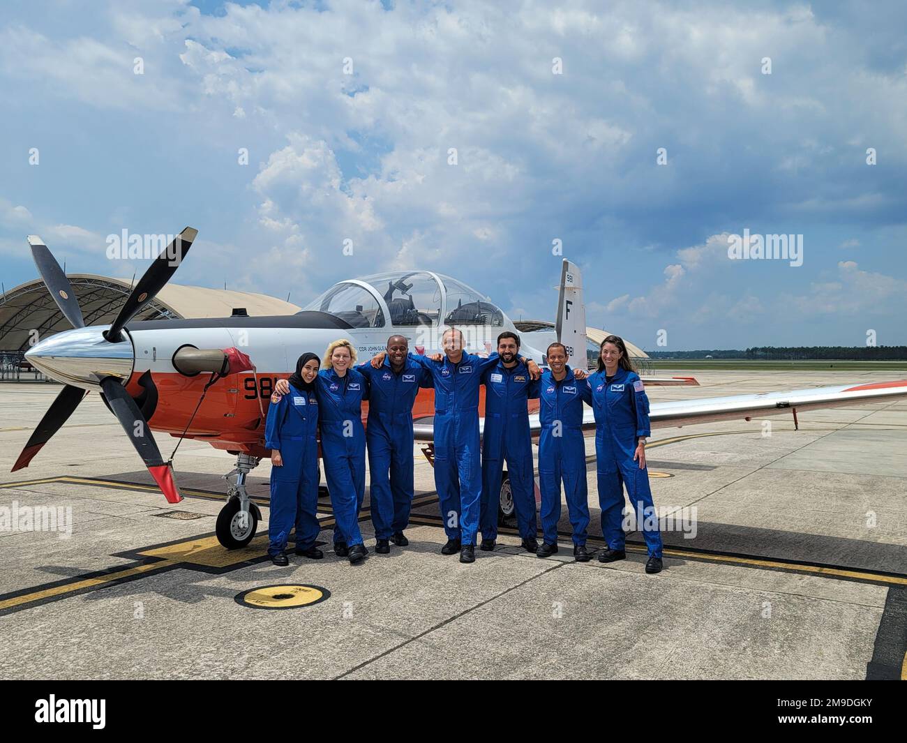 NASA astronaut candidates Christina Birch, Andre Douglas, Deniz Burnham, Christopher Williams, Anil Menon, Nora Al Matrooshi and Mohammad Al Mulla stand beside a T6-A Texan II at Naval Air Station Pensacola, May 17. The astronaut candidates began Basic Aviation Curriculum at Training Air Wing Six in late March as part of a two-year training pipeline in preparation for serving the Artemis space exploration program. Stock Photo