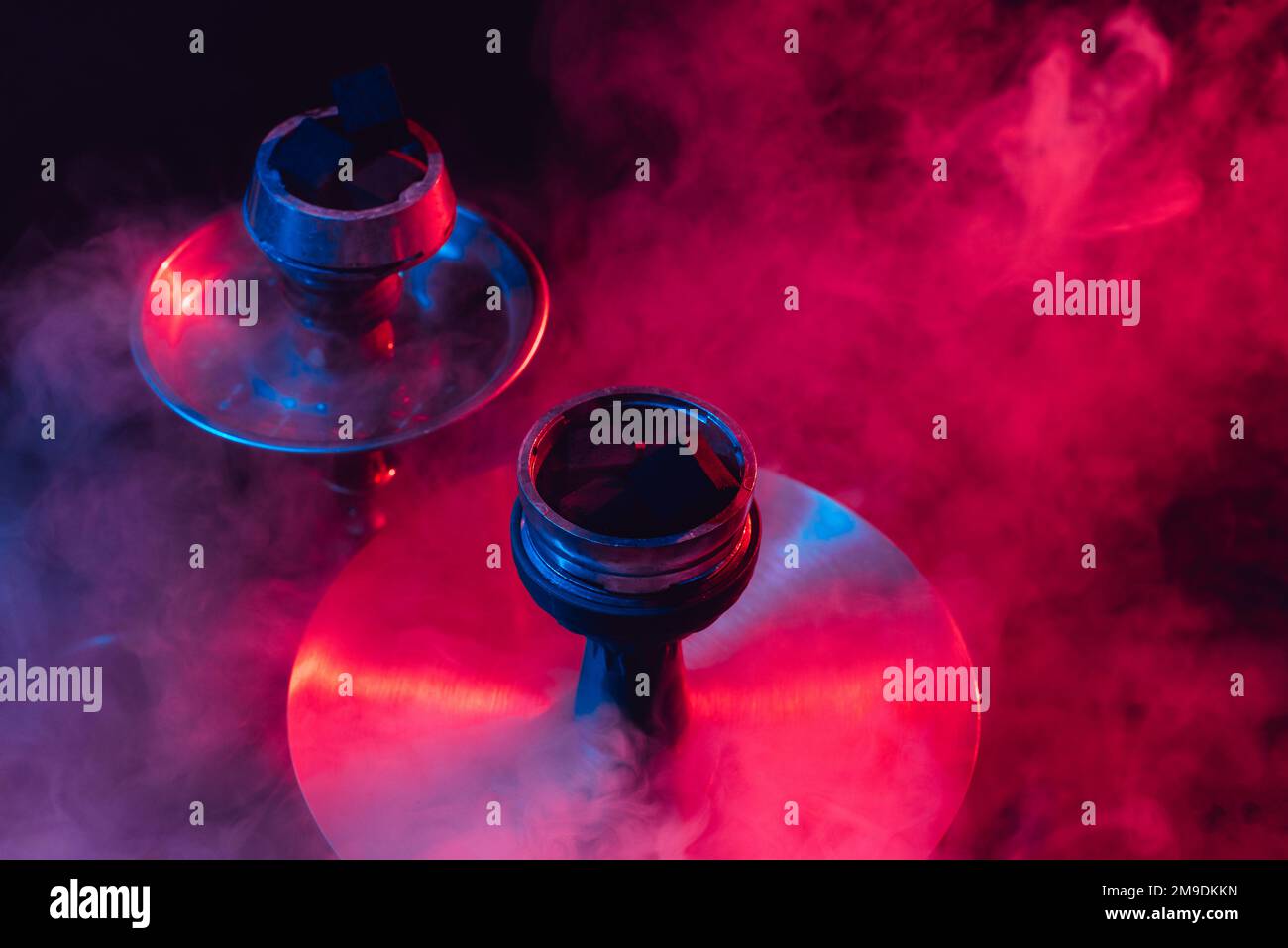 hookah bowl and coals close up on black background with smoke Stock Photo