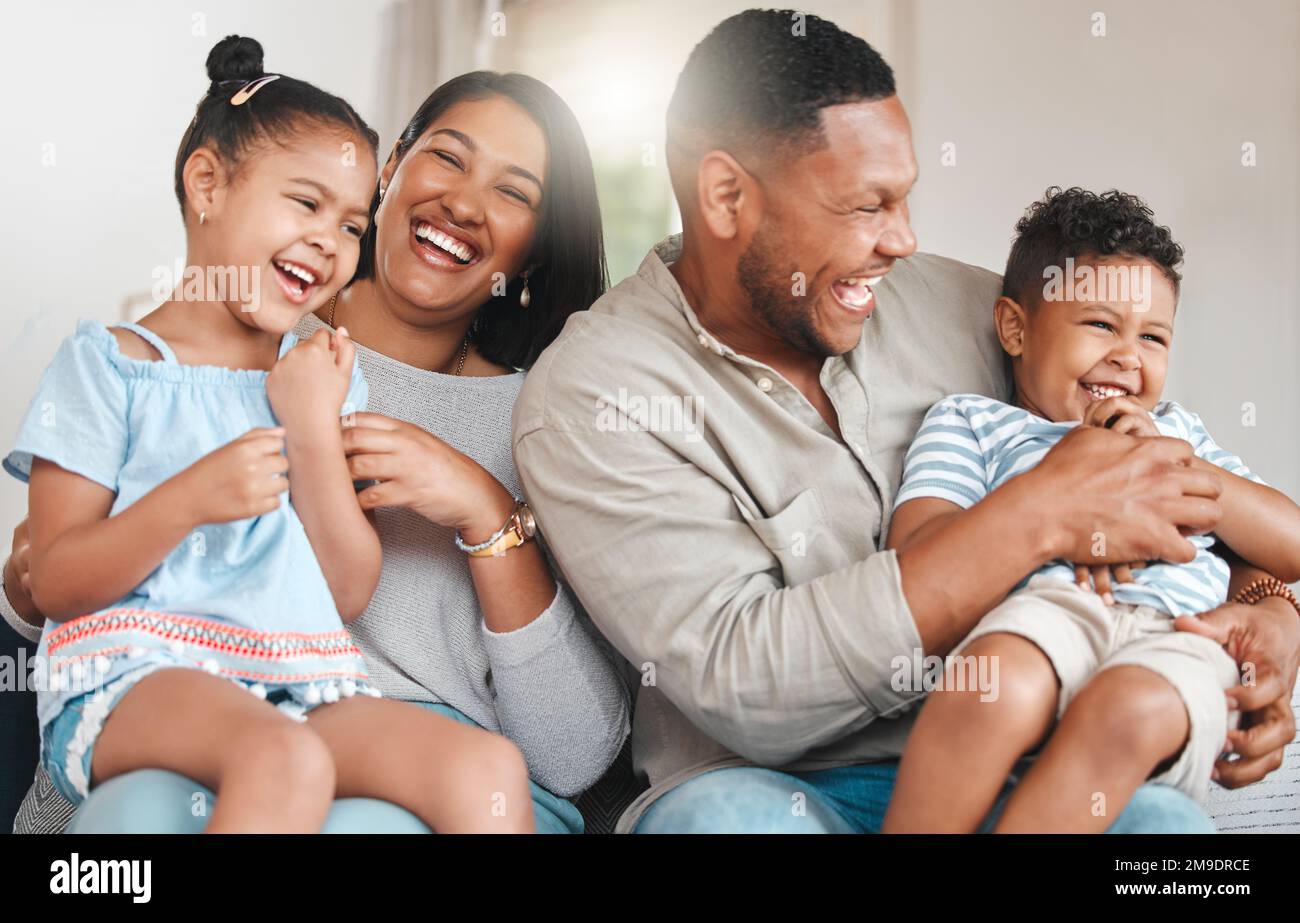 Theyre my reason. a young family playing together on a sofa at home. Stock Photo