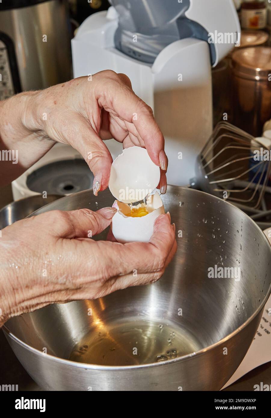 Chef separates the yolk from the protein to make the pie. Stock Photo