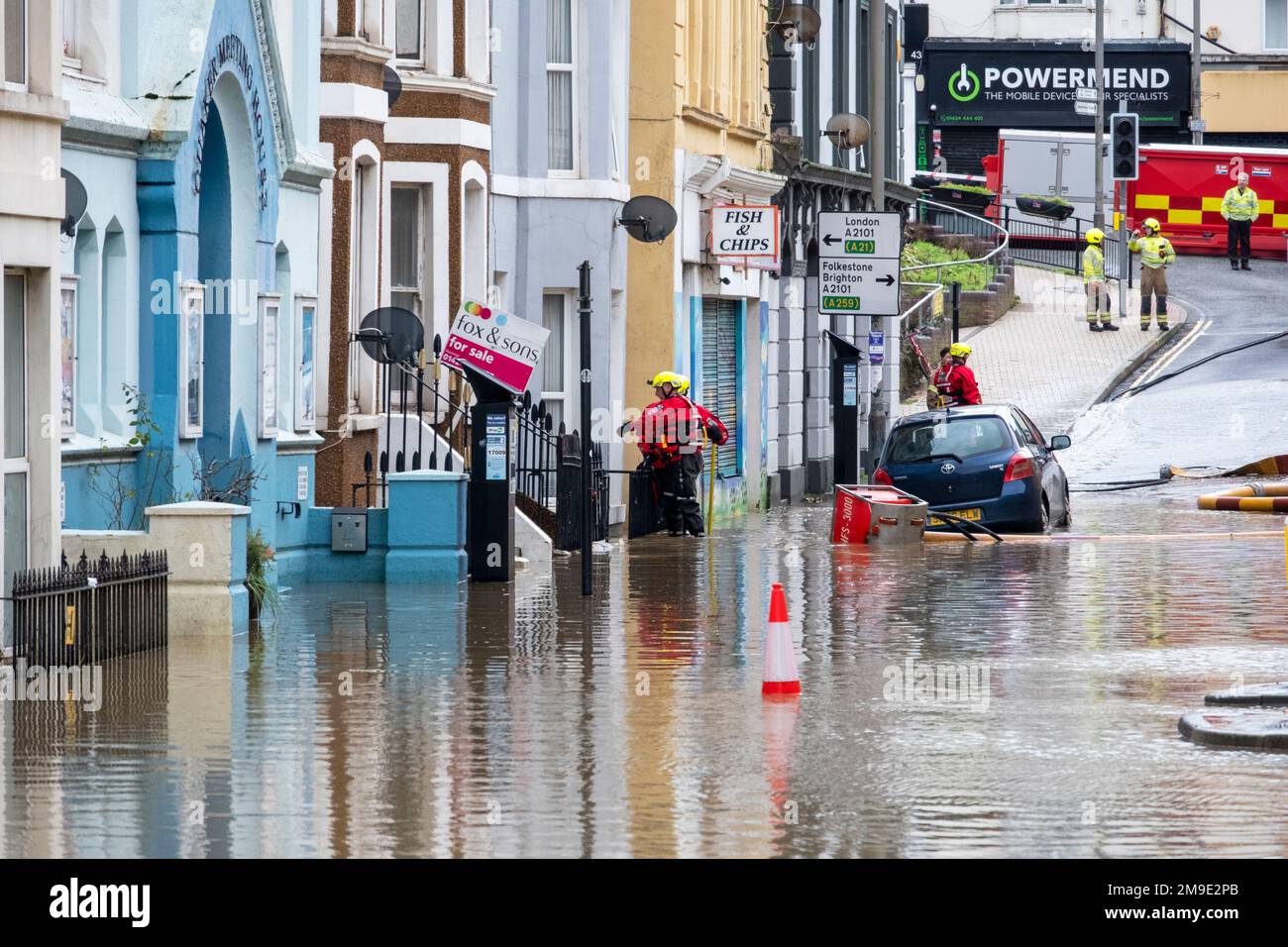 Fire brigade pumps out floodwater from homes and businesses after heavy rain causes flooding in Hastings town and closes Priory Meadow shopping centre Stock Photo