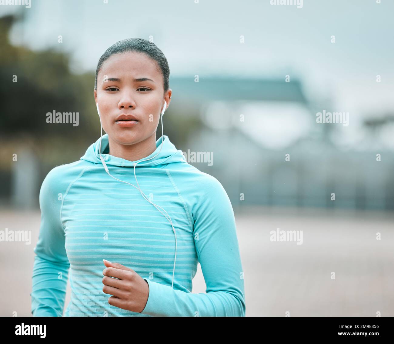 Feeling the burn in my legs. a young woman running outside Stock Photo