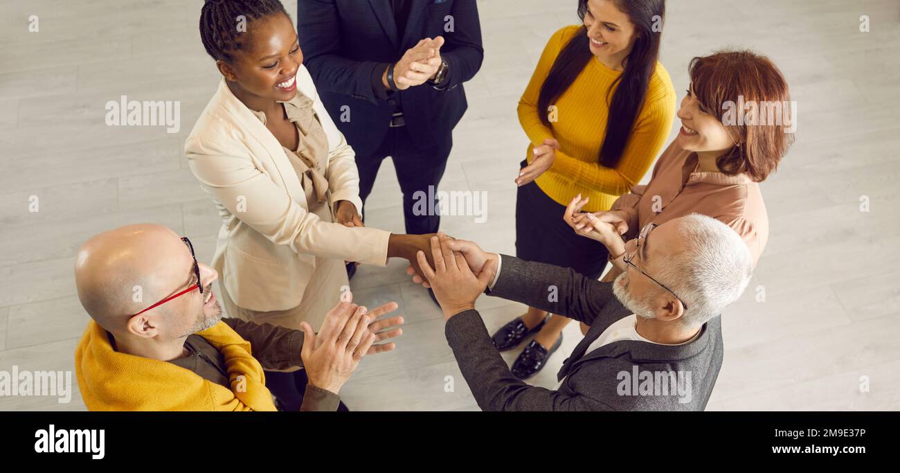 Group of happy multiracial people meeting and getting acquainted at business event Stock Photo