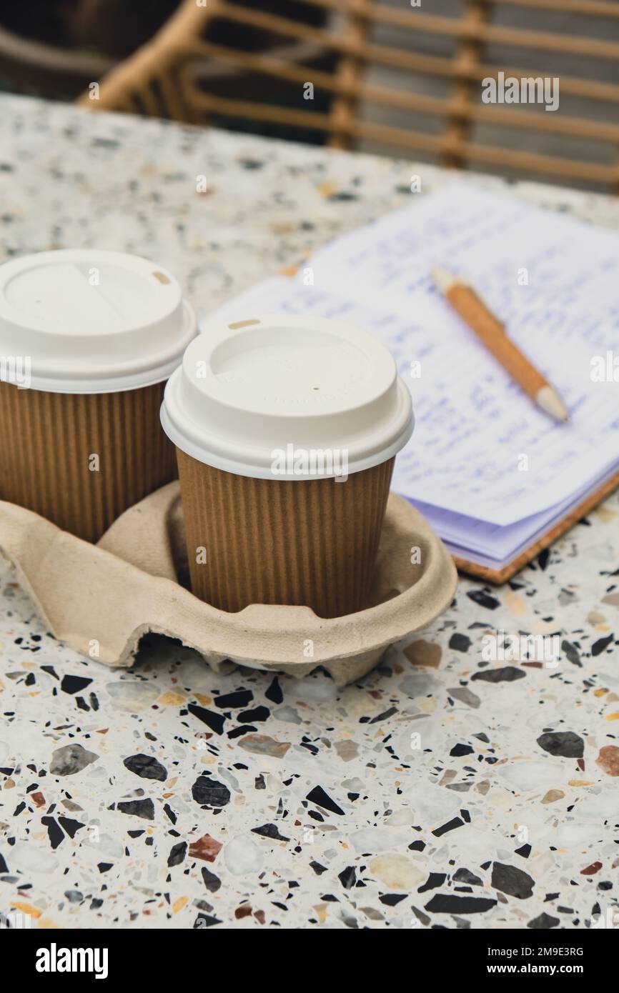 Two paper cups with lid for tea to go. Coffee take away on the table