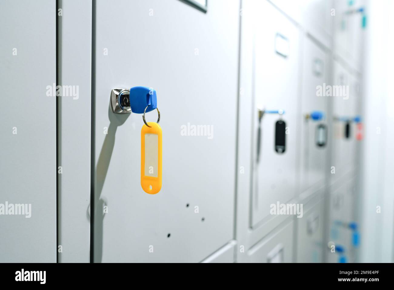 Gray locker with key for safety in public facility Stock Photo