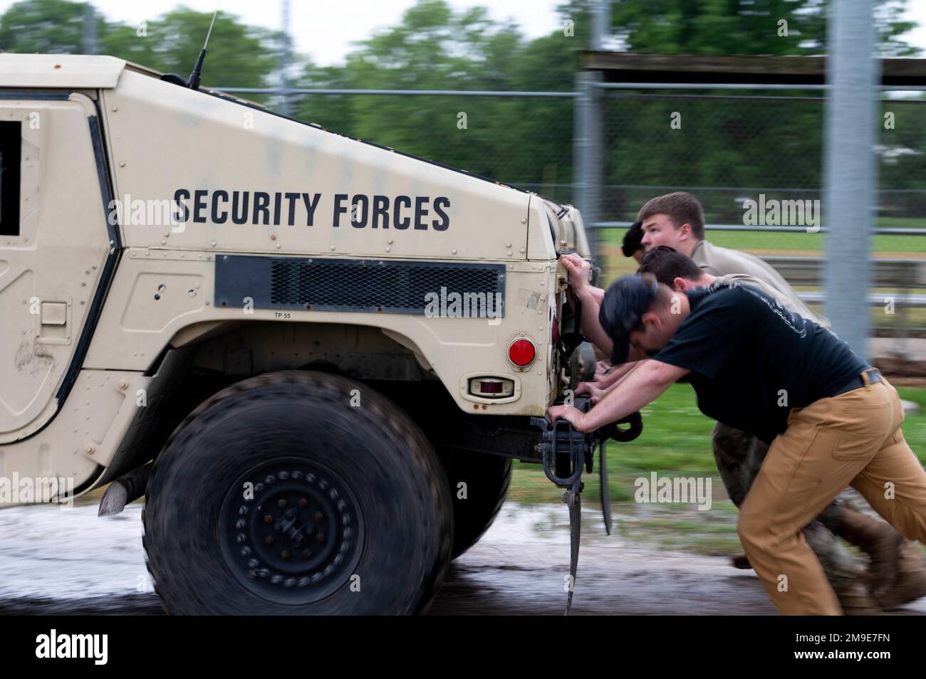 U.S. Air Force Airmen from the 375th Air Mobility Wing push a Humvee ...
