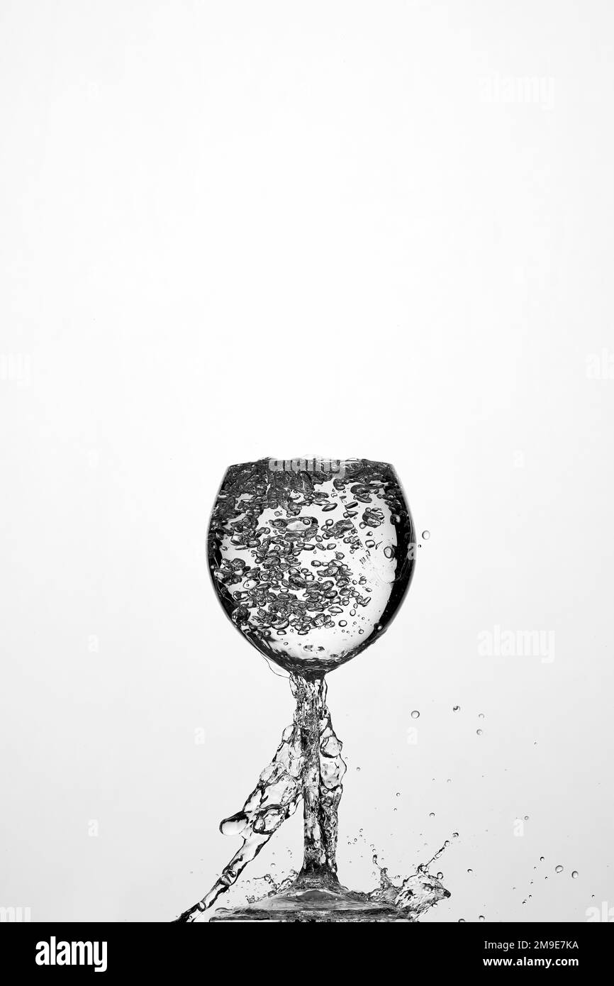 Backlight shot water in glass, air bubbles, white background Stock Photo