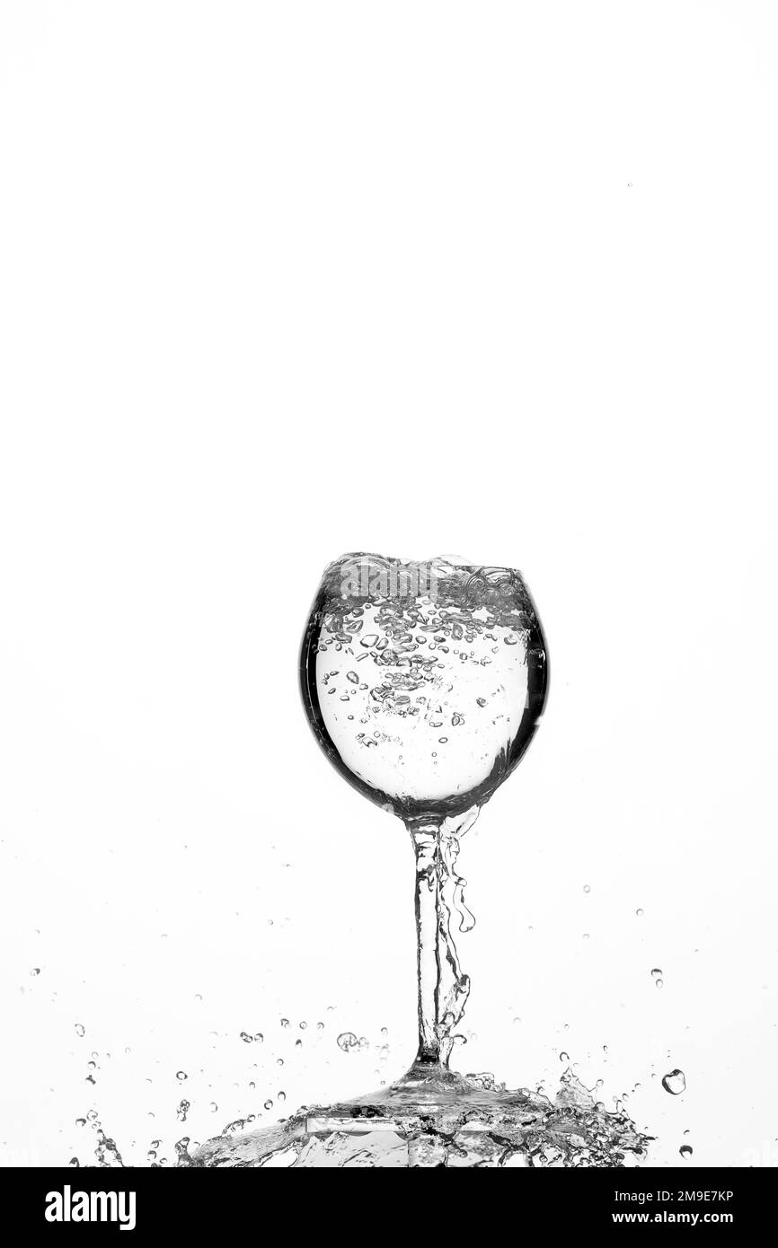 Backlight shot water in glass, air bubbles, white background Stock Photo