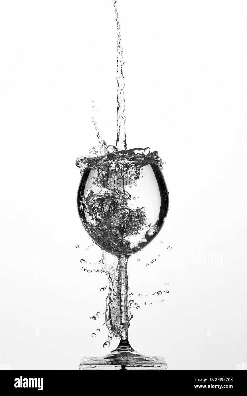 Backlight shot water fountain in glass, white background Stock Photo