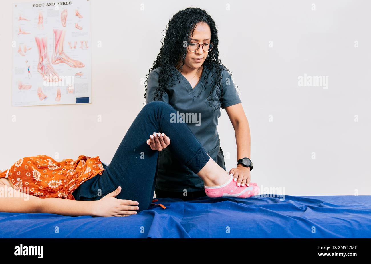 Worker In Modern Physiotherapy Assisting Female Patient Professional Worker In Modern Physiotherapy Assisting Female Patient Professional