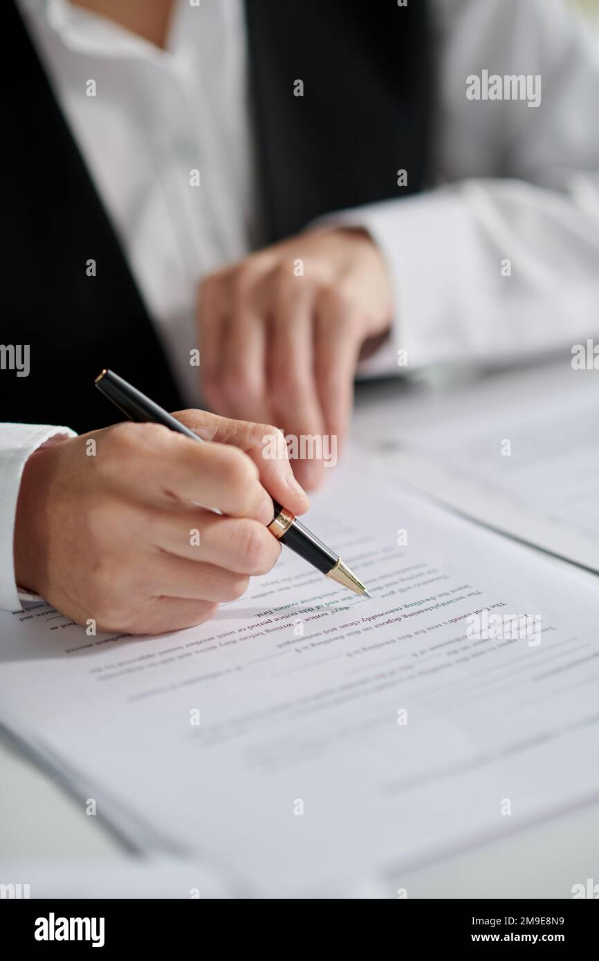 Closeup image of social worker signing document Stock Photo