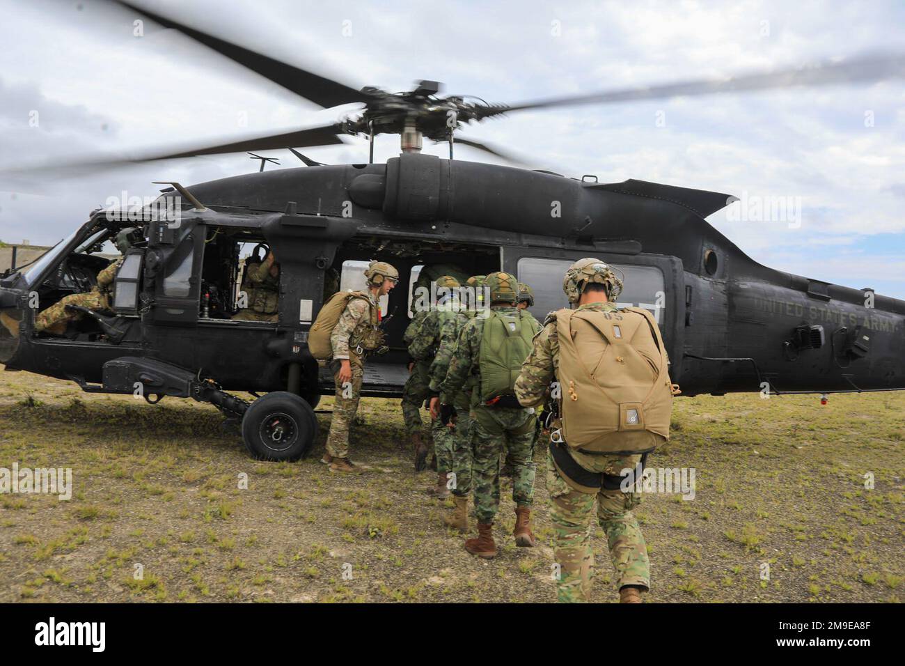 Members of the 7th Special Forces Group (Airborne) along with their Ecuadorian Special Forces partners load onto a MH-60 Blackhawk to conduct high altitude, low opening (HALO) jump in Manta, Ecuador, May 19, 2022. Ecuadorian military and US forces are conducting routine military exchanges from May 6-27 between the cities of Manta and Latacunga. Bilateral exchanges allow both militaries to strengthen tactical readiness for future operations maintain readiness and support continue commitment in responding to emerging security crises and natural disasters.    ( U.S. Army photos by Staff Sgt. Matt Stock Photo