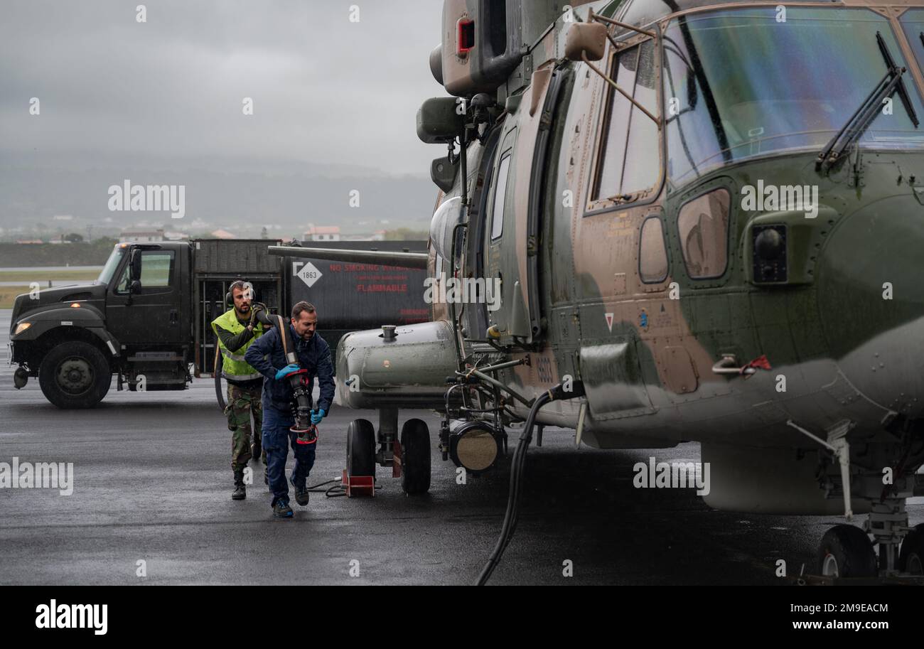 U.S. and Portuguese Air Force carry a fuel hose at Lajes Field, Azores