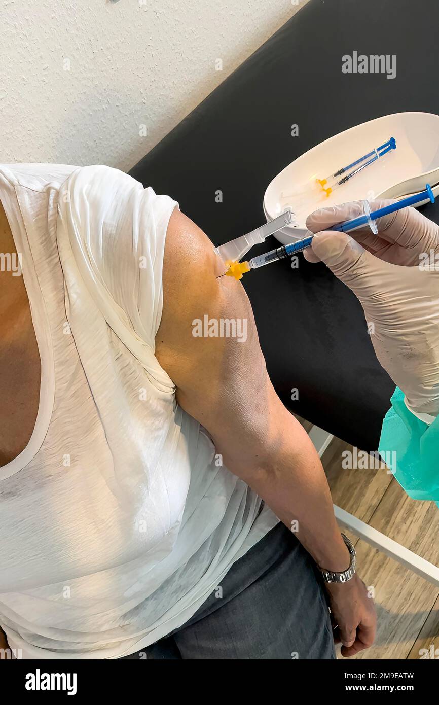 Injection Booste Elderly woman receives injection with medical syringe fourth ...
