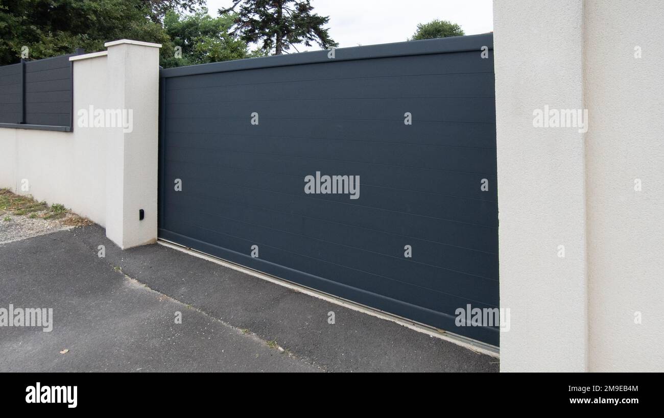 portal suburban closed aluminium steel gate brown on home street access house garden Stock Photo
