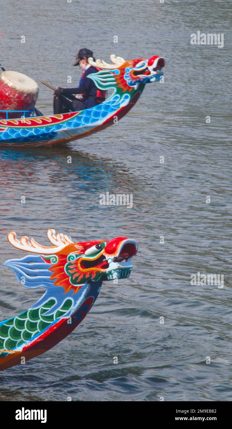 A vertical shot of dragon boat heads during the Asian traditional