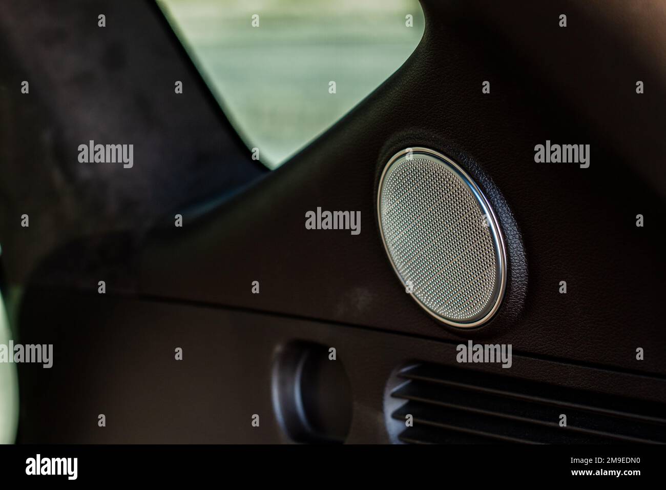 Sound speaker in a modern car trunk. Close up car speaker inside car