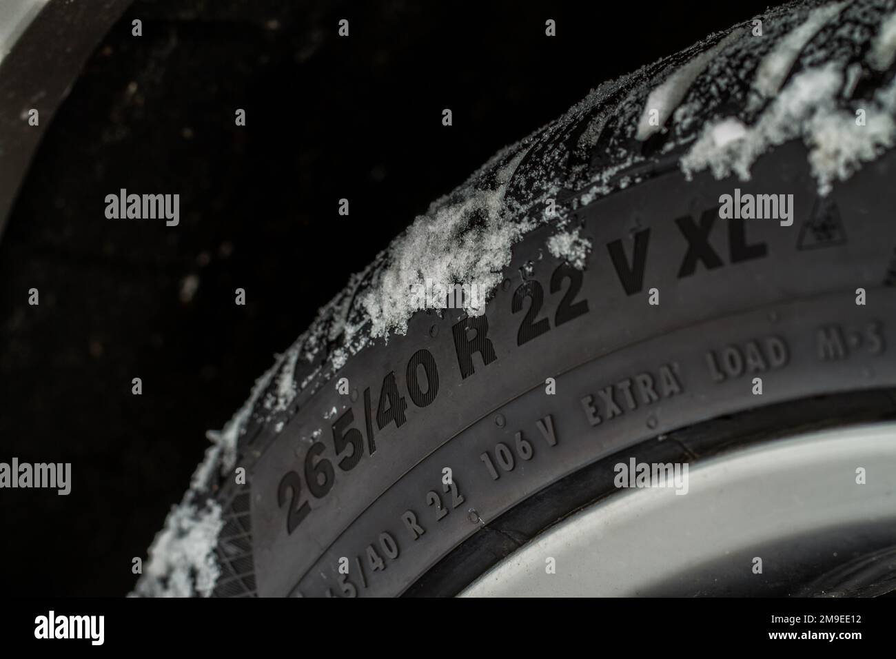 Close up view of snowy tire with tire width, height and wheel diameter