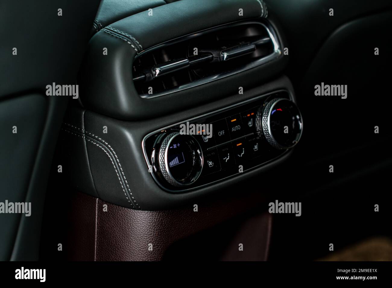 Modern car. Digital second row seat temperature control. Car air conditioning system button. Automatic climate control system. Fan speed and temperatu Stock Photo