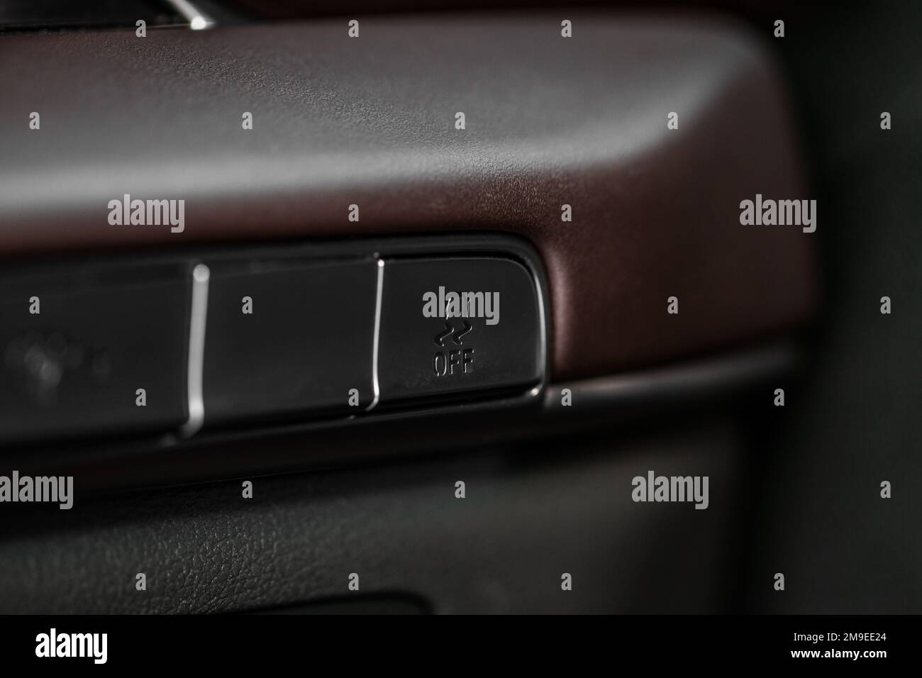 Hand operating ESP (electronic stability program) control close up view