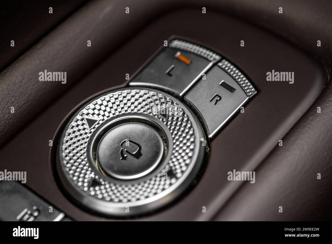 Side mirrors control panel on side door. Car driver adjust side mirror