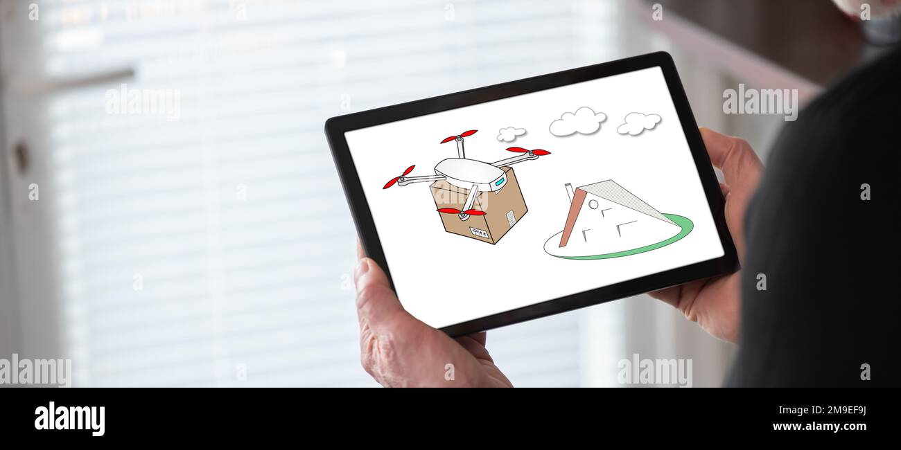 Drone delivery concept shown on a tablet held by a man Stock Photo