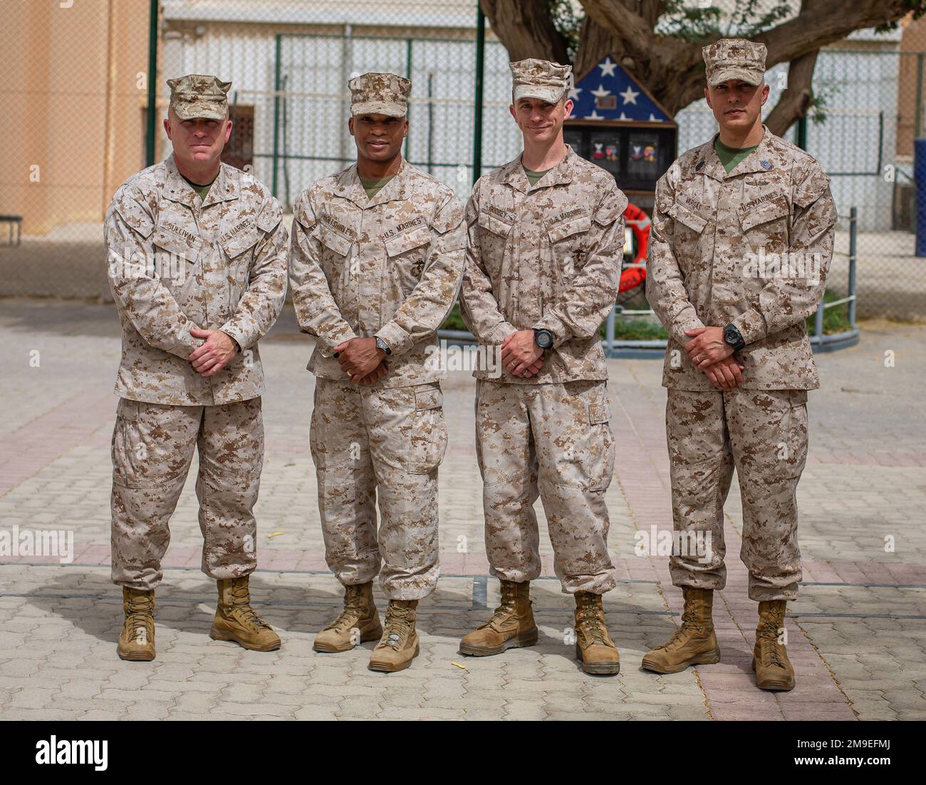 NAVAL SUPPORT ACTIVITY, Bahrain (May19, 2022) - Marine Brig. General Farrell Sullivan, the Commanding General of Task Force 51/5th Marine Expeditionary Brigade (TF 51/5), far left, Maj. Tracey Holtshirley, the incoming Commanding Officer of TF 51/5 Headquarters Company (HQ Co.), left, Maj. Alexander Godbey, the outgoing Commanding Officer of TF 51/5 HQ Co., right, and Sgt. Maj. Rafael Vargas, The Sergeant Major of TF 51/5, far right, pose for a picture after the TF 51/5 HQ Co. change of command ceremony aboard Naval Support Activity Bahrain, May 19. During the ceremony, Godbey relinquished com Stock Photo