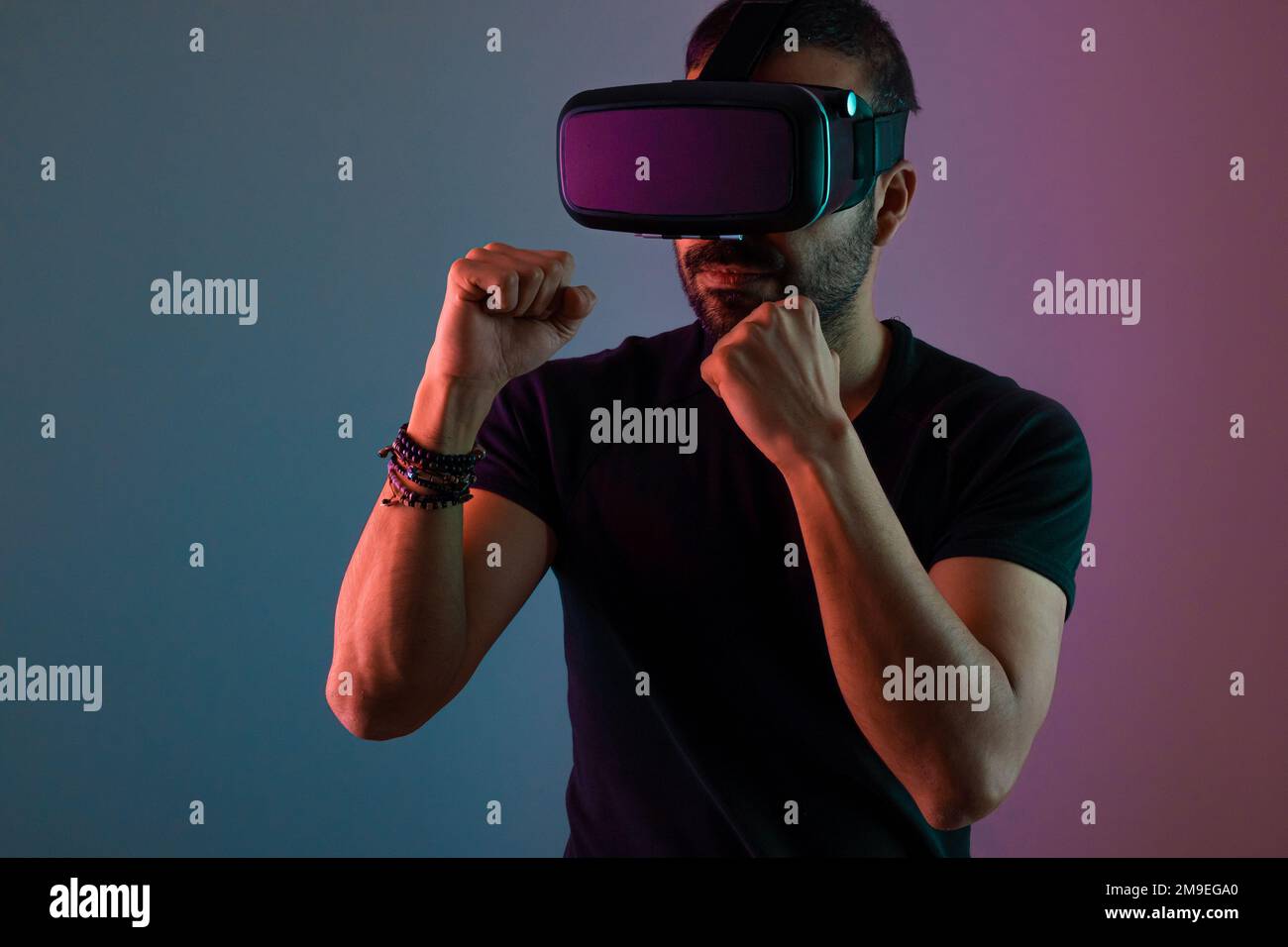 Virtual reality workout, sport game. young man in neon color with VR