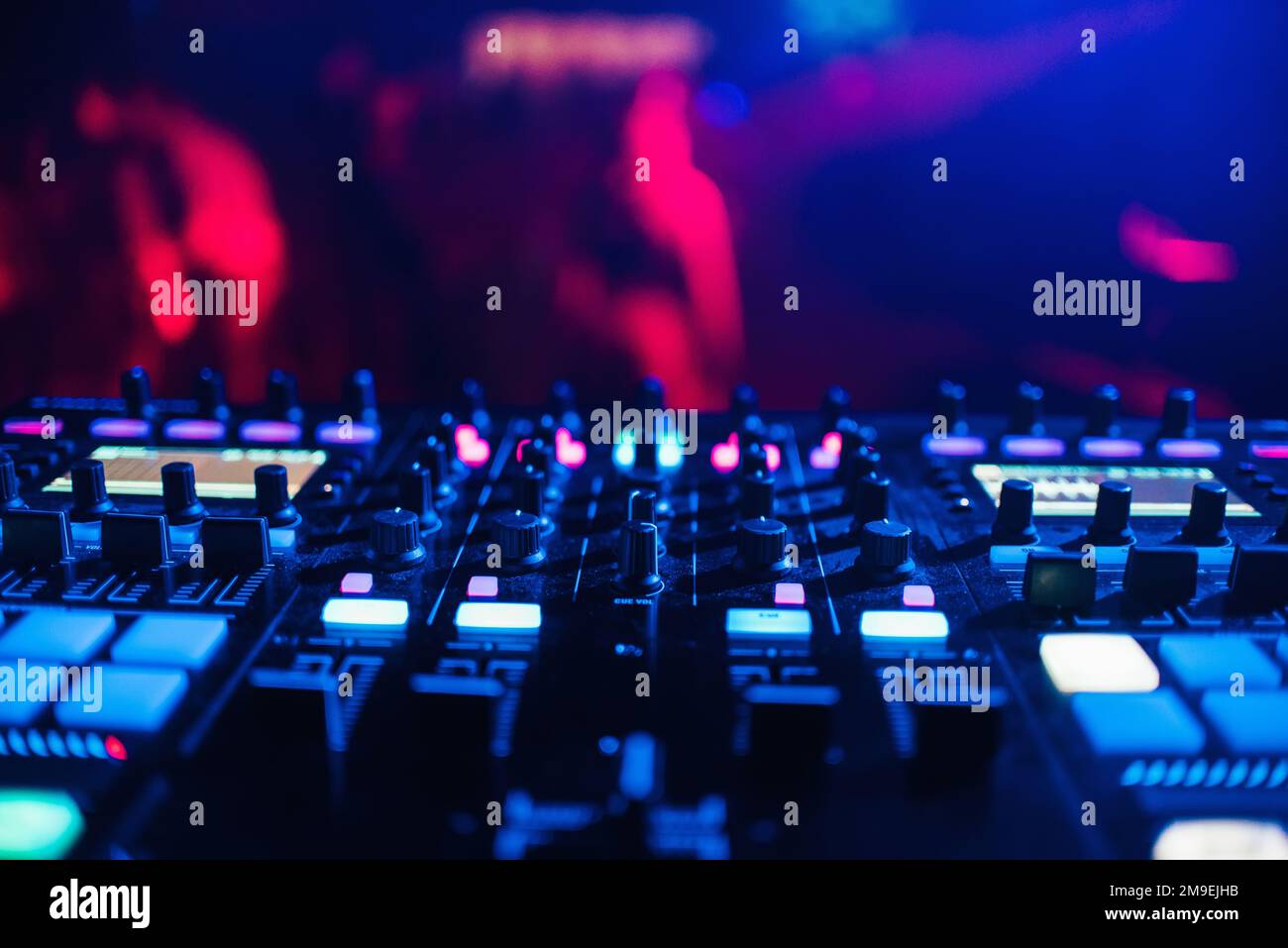 DJ mixer on the table background the night club and dancing people Stock Photo Alamy