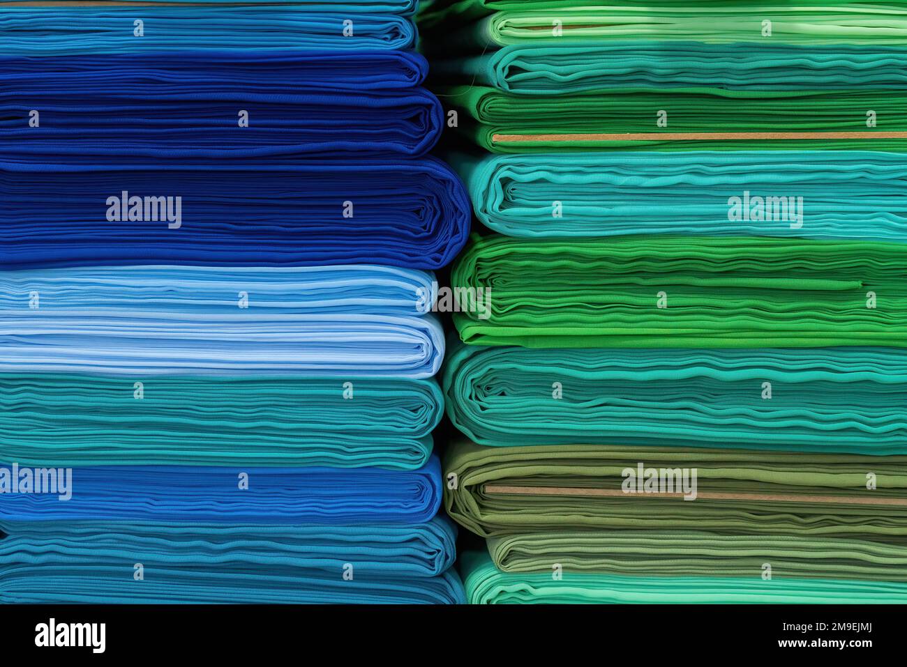 Layers of colorful fabric, colorful background. Pile of bright rolls of