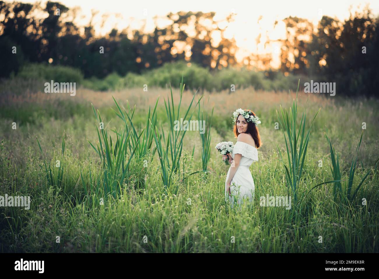 Happy Girl In A White Dress And A Bouquet Of Flowers Smiles And Joy In