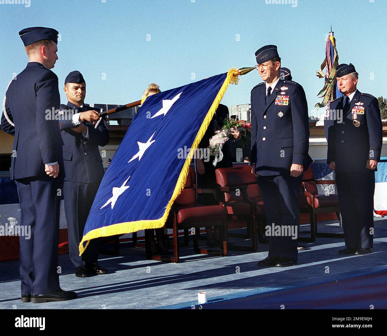 US Air Force Captain Bill Rupp (Far left), Executive Officer to Lieutenant General John B. Sams the Commander of 15th Air Force, stands ready to encase the flag while Technical Sergeant T.J. Silva (2nd from left), Enlisted Aide to LTGEN Sams, retires the 3 star flag that once flew for the former 15th Air Force Commander. General Tony Robertson (3rd from left), Air Mobility Command Commander at Scott Air Force Base, Illinois, presides over the ceremony. Base: Travis Air Force Base State: California (CA) Country: United States Of America (USA) Stock Photo