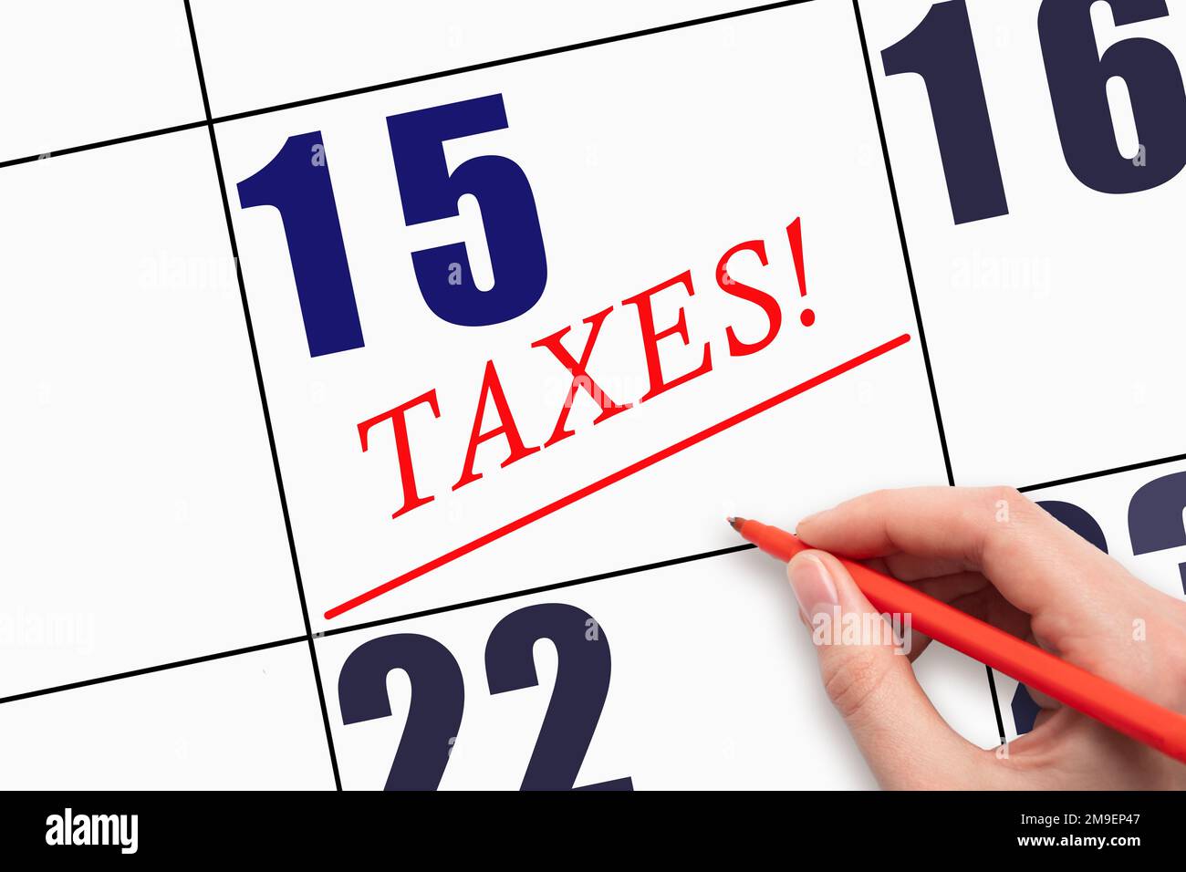 15th day of the month Hand writing text TAXES and drawing a line on 15th day of the month Hand writing text TAXES and drawing a line on