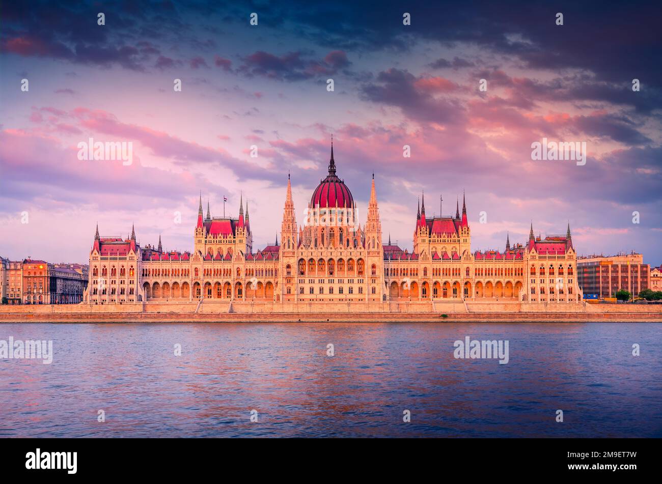 Budapest, Hungary. Colored sunset sky over Danube River and Hungarian Parliament, famous European capital. Stock Photo