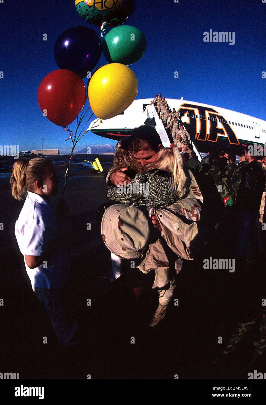 US Air Force Technical Sergeant James Kahlandt returns home to Hill AFB, Utah from Southwest Asia under the Aerospace Expeditionary Force (AEF) rotation system in December, Sergeant Kahlandt got more time to spend with daughters Brittany, Alissa and his wife Vicky. From the March 2000 AIRMAN Magazine article 'No More Guessing Games.'. Base: Hill Air Force Base State: Utah (UT) Country: United States Of America (USA) Stock Photo