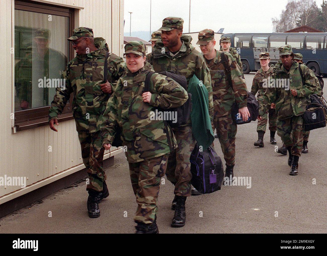 Medium shot, front view, personnel, carrying individual luggage, 86th Airlift Wing, Ramstein Air Base, Germany, walk toward camera, prepare for departure on 7 March 2000, for Operation 'BRILLIANT LION,' in Cameroon, Africa. 'BRILLIANT LION' is a medical exercise to provide medical aide to six villages in Cameroon and is the largest medical exercise of its type for the United States European Command. Subject Operation/Series: BRILLIANT LION Base: Ramstein Air Base State: Rheinland-Pfalz Country: Deutschland / Germany (DEU) Stock Photo
