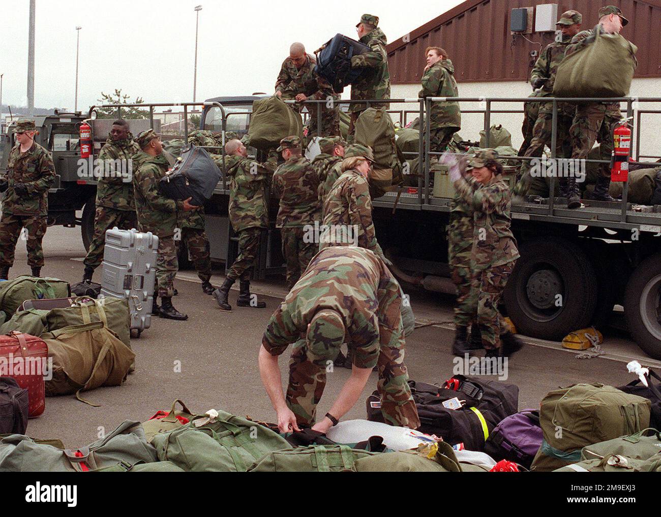 Medium shot, members of the 86th Medical Group, 86th Airlift Wing, Ramstein Air Base, Germany, load luggage, on flatbed 'K' loader prior to departure on 7 March, 2000, for Operation 'BRILLIANT LION,' in Cameroon, Africa. 'BRILLIANT LION' is a medical exercise to provide medical aide to six villages in Cameroon and is the largest medical exercise of its type for the United States European Command. Subject Operation/Series: BRILLIANT LION Base: Ramstein Air Base State: Rheinland-Pfalz Country: Deutschland / Germany (DEU) Stock Photo