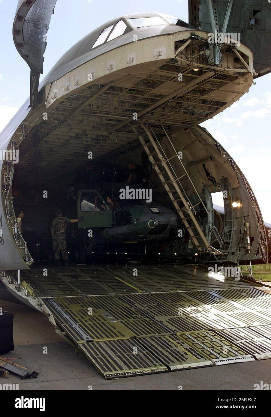 Medium shot, right front view, a parked C-5 Galaxy, nose visor raised and crago ramp extended, 436th Airlift Wing, Dover Air Force Base, Delaware, delivers a HH-60 Blackhawk, 41st Rescue Squadron, Moody AFB, Georgia, 7 March 2000, to South African Air Force Base Hoedspruit during Operation 'ATLAS RESPONSE'. The helicopter is the first delivered to aid in distribution of relief supplies and to be used in rescue operations for stranded flood victims in Mozambique. (Duplicate image, see also DF-SD-01-05897 or search 000307-F-5772H-503). Subject Operation/Series: ATLAS RESPONSE Base: Hoedspruit Ai Stock Photo
