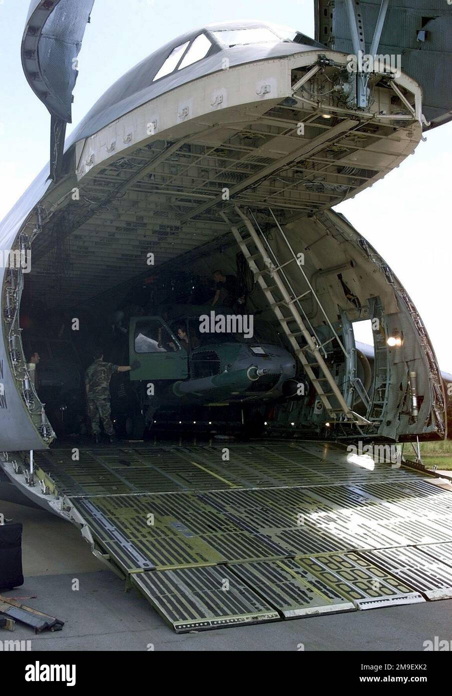 A C-5 Galaxy transport aircraft from 436th Airlift Wing, Dover Air Force Base, Delaware, delivers cargo pallets, personnel, and two HH-60 Blackhawk helicopters from the 41st Rescue Squadron, Moody AFB, Georgia, to AFB Hoedspruit, South Africa, during Operation Atlas Response. The personnel and helicopters are the first American HH-60's delivered to aid in the distribution of relief supplies and rescue stranded flood victims in Mozambique, 7 March 2000. (Duplicate image, see also DF-SD-01-02914 or search 000307-F-5772H-503 ). Subject Operation/Series: ATLAS RESPONSE Base: Hoedspruit Air Force B Stock Photo