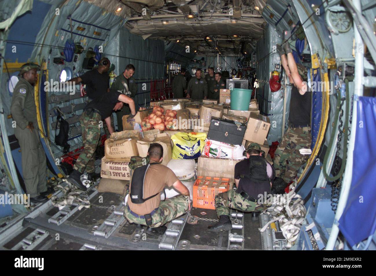 A C-130 Hercules interior medium shot as US Air Force members of the 86th Air Mobility Squadron, Ramstein Air Base, Germany, unload by hand 13,000 pounds of loose humanitarian refeif supplies at the International Airport at Maputo, Mozambique, Africa on 16 March 2000. This team is deployed here in support of Operation Atlas Response, a Humanitarian Aid Operation to help the people of Mozambique, after severe flooding (flooding and victims not shown) displaced over a million people from their homes. Subject Operation/Series: ATLAS RESPONSE Base: Maputo State: Inhambane Country: Mozambique (MOZ) Stock Photo