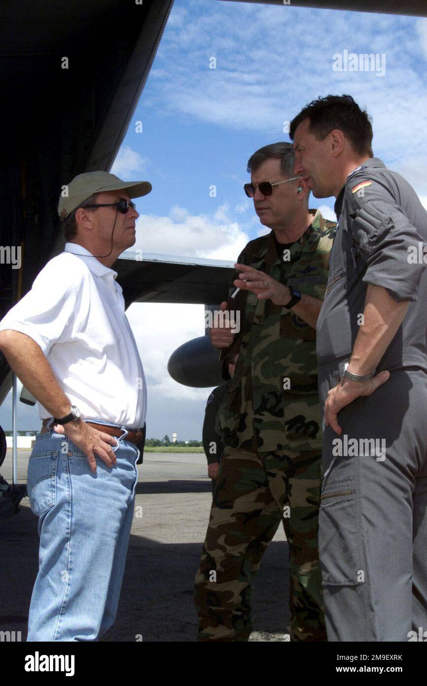 The United States Ambassador to Mozambique, Dean Curran (left) and United States Air Force Major General Joseph H. Wehrle Jr. (center), Commander 3rd Air Force and Commander of Joint Task Force Operation Atlas Response, discuss the delivery of humanitarian relief supplies with German Air Force Colonel Joachim Wundrak (right), the commander of the German contingent. To date, Joint Task Force aircraft participating in Operation Atlas Response have delivered more than 71 tons of humanitarian relief supplies on 102 flights to more than 20 locations. Maputo International Airport, Mozambique, 16 Mar Stock Photo
