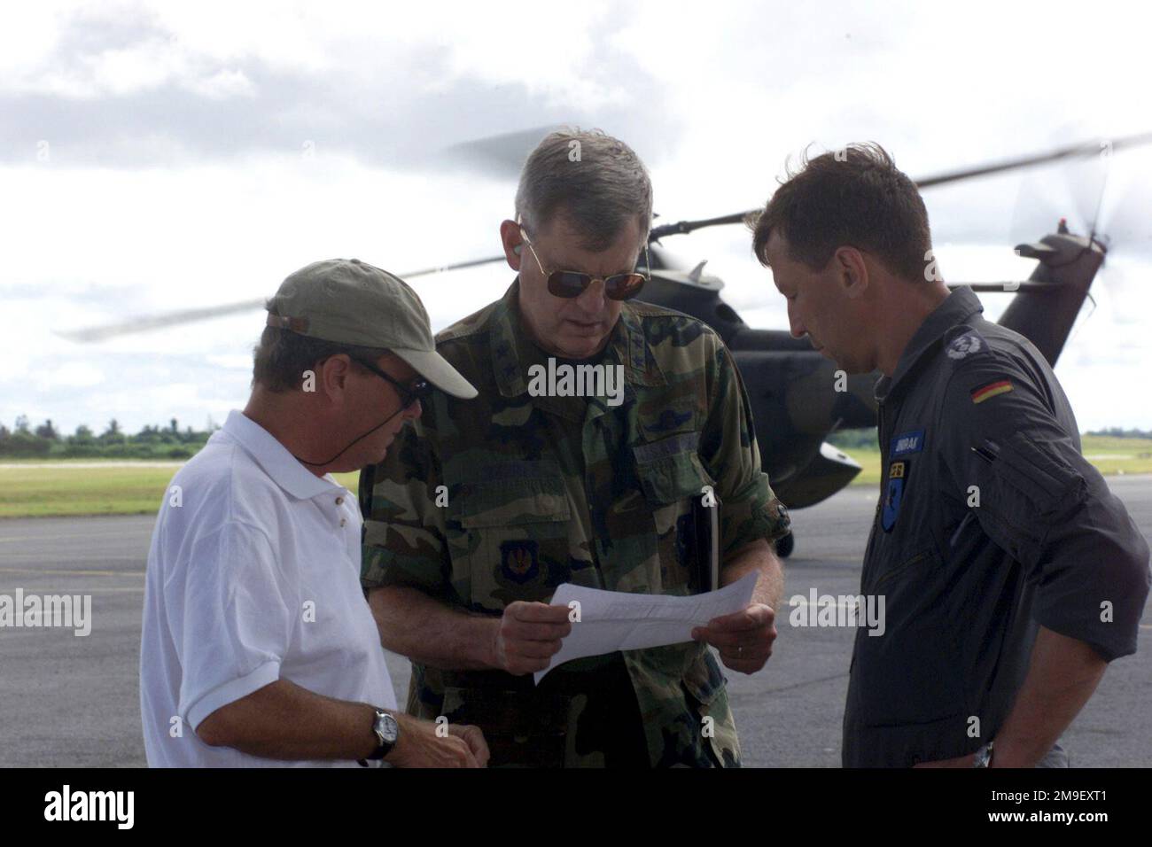 The United States Ambassador to Mozambique, Dean Curran (left) and United States Air Force Major General Joseph H. Wehrle Jr. (center), Commander 3rd Air Force and Commander of Joint Task Force Operation Atlas Response, discuss the delivery of humanitarian relief supplies with German Air Force Colonel Joachim Wundrak (right), the commander of the German contingent. To date, Joint Task Force aircraft participating in Operation Atlas Response have delivered more than 71 tons of humanitarian relief supplies on 102 flights to more than 20 locations. Maputo International Airport, Mozambique, 16 Mar Stock Photo