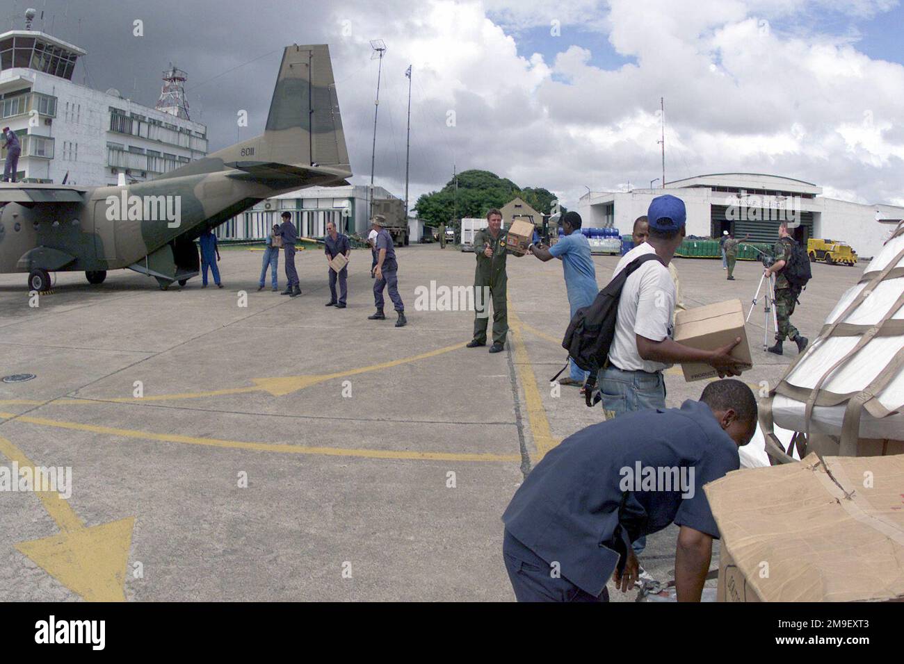 A straight on medium shot as a South African aircrew and local laborers load a South African Air Force aircraft, with humanitarian relief supplies destined for Beira, Mozambique, at the International Airport at Maputo, Mozambique, Africa on 16 March 2000. The South African Air Force along with several other nations (not shown) from around the world are in Maputo, to help the people of Mozambique, after severe flooding (flooding and victims not shown) displaced over a million people from their homes. Subject Operation/Series: ATLAS RESPONSE Base: Maputo State: Inhambane Country: Mozambique (MOZ Stock Photo