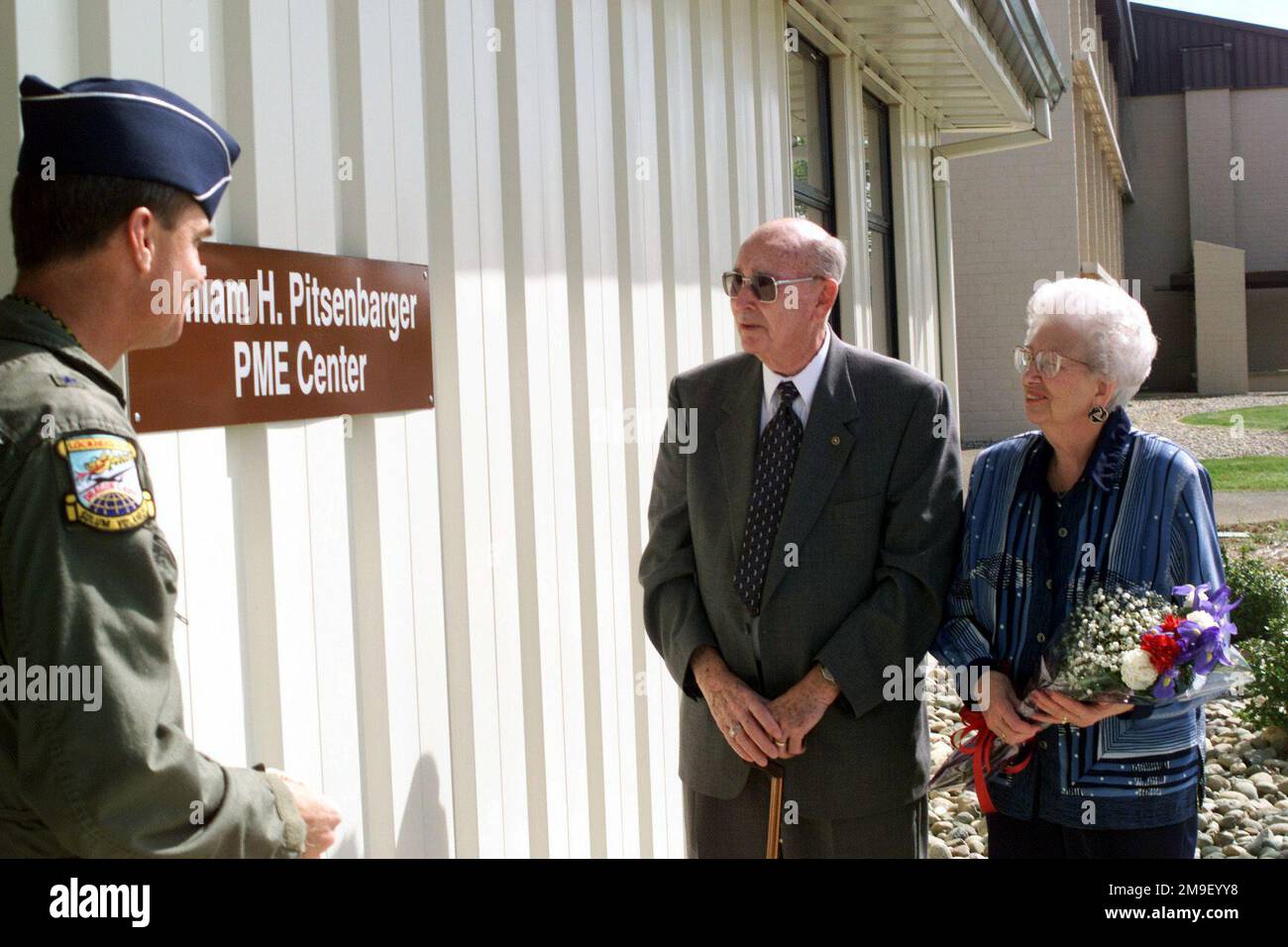 Right side profile medium close-up shot as US Air Force Brigadier General Kevin Chilton, 9th Reconnaissance Wing Commander, Frank Pitsenbarger and his wife Alice look at the newly revealed sign on April 11, 2000 at Beale AFB, California. The sign displays the new name for the Beale's AIRMAN Leadership Schools (William H. Pitsenbarger PME Center). AIRMAN Pitsenbarger was awarded the Air Force Cross, an honor that only 21 airmen have earned, for his sacrifice and bravery. AIRMAN Leadership staff felt that AIRMAN 1ST Class William H. Pitsenbarger was an enlisted role model who displayed a true-li Stock Photo