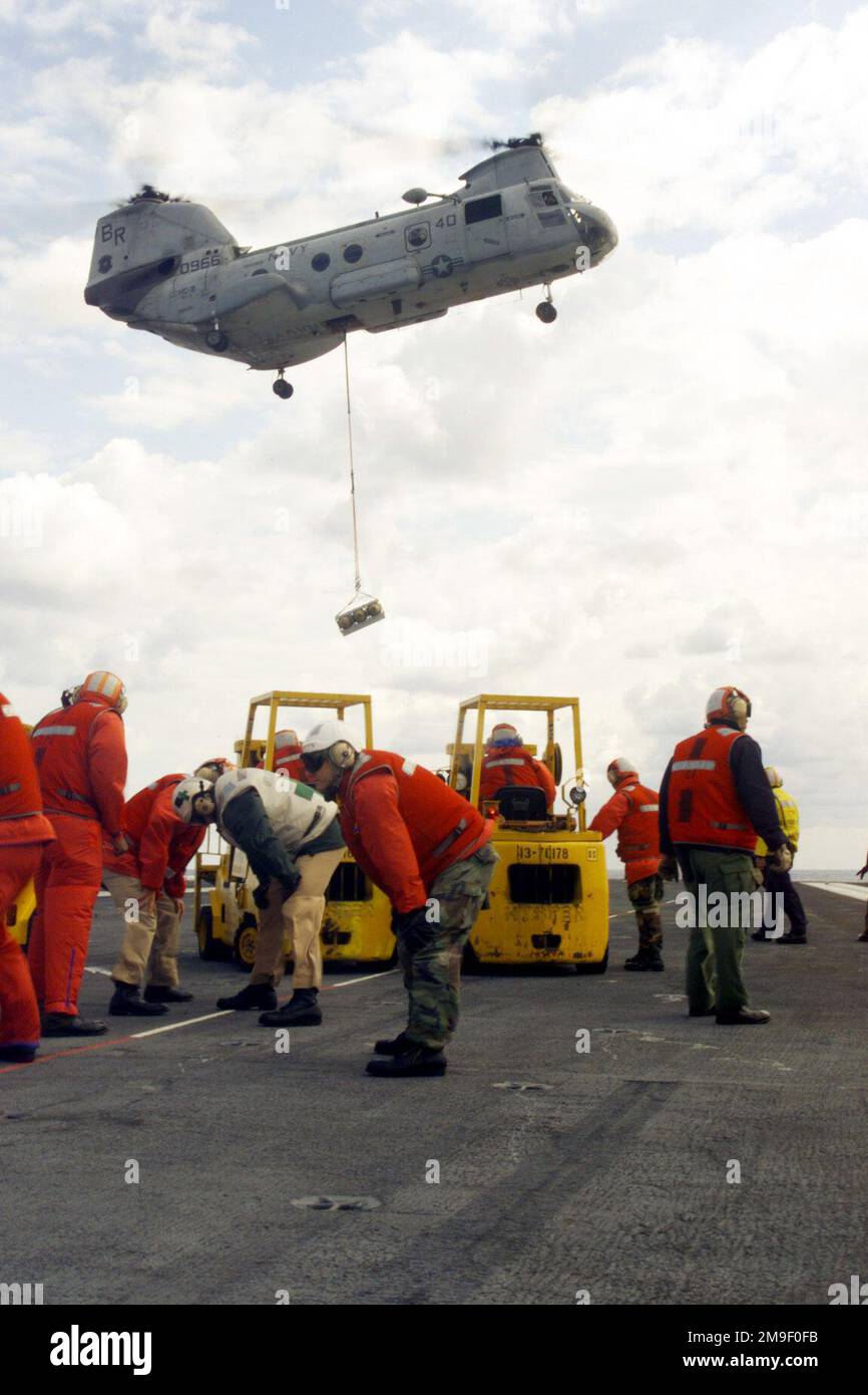 Aviation Ordnancemen brace themselves from the rotor wash of an ...