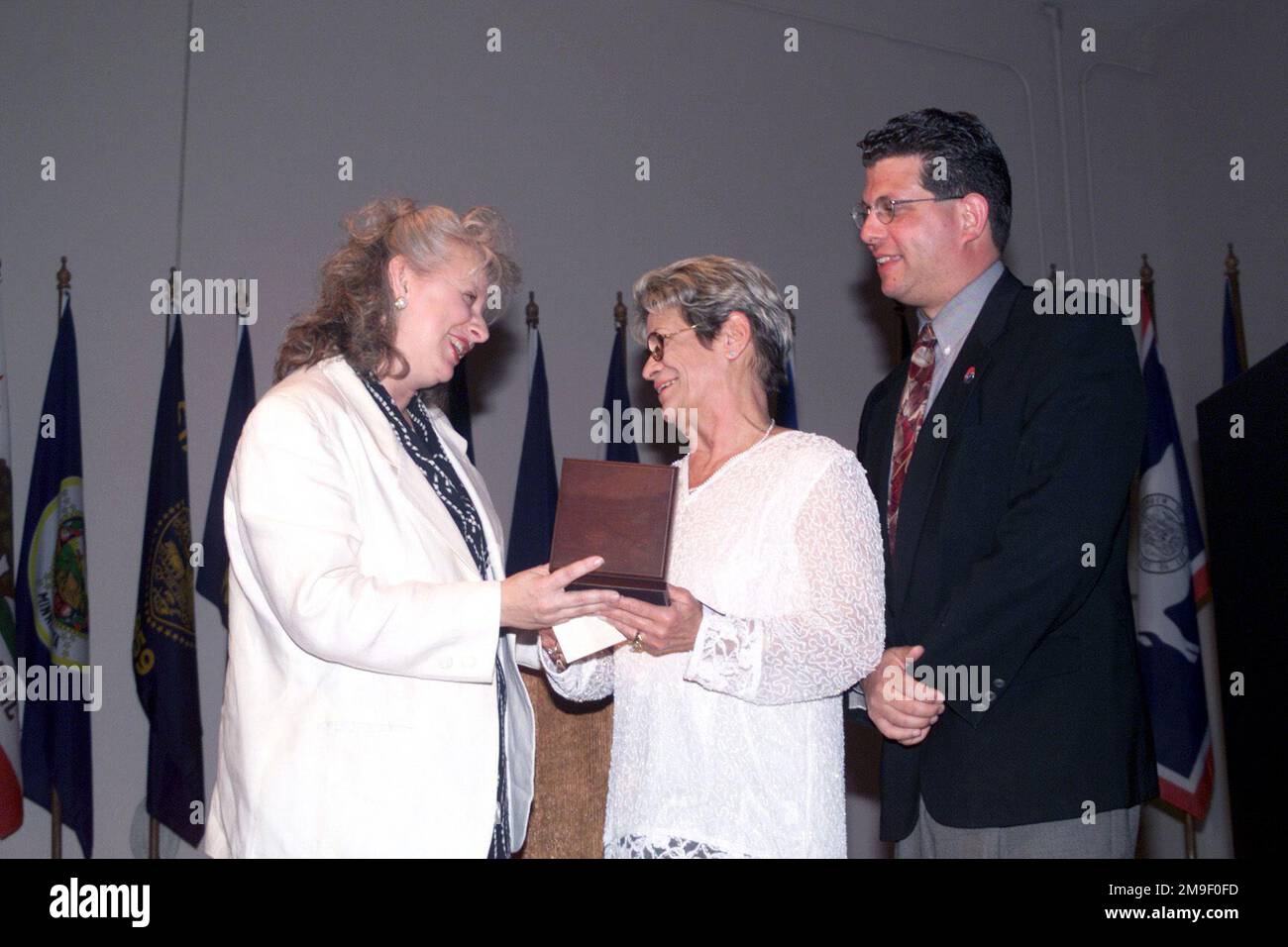 An interior, right side profile medium shot as Joan Dempsey (Left